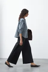 Jean de calce ultra wide confeccionado en denim de algodón color negro. Presenta una silueta amplia desde la cadera y un panel lateral en contraste que estiliza la pierna.