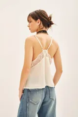 Top blanco de crepe con breteles regulables y escote en V con encaje.
