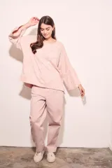 Sweater rosa con mangas acampanadas y cuello redondo. Tejido suave y confortable de algodón, acrílico y lino.