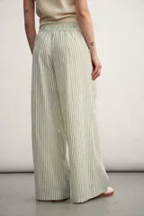 Pantalón palazzo a rayas verticales color beige y blanco, de tiro alto y corte amplio.