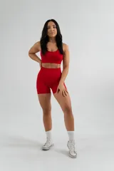 Conjunto deportivo rojo compuesto por un top con tirantes finos y unos shorts ajustados de tiro alto.