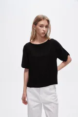 Blusa negra de viscosa, corte holgado y cuello redondo.