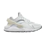 Zapatillas Nike Air Huarache blancas con detalles en gris y suela negra.