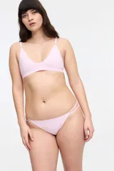 Conjunto de ropa interior color rojo, compuesto por un corpiño triangular de punto canalé con tirantes regulables y una bombacha colaless con tiras dobles en los laterales.