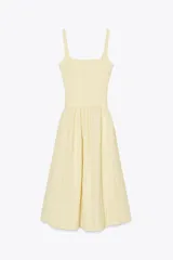 Vestido midi color amarillo pálido con textura arrugada, escote cuadrado, tirantes anchos y falda acampanada.