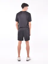Short deportivo negro de poliéster con cintura elástica y logo estampado en la pierna.