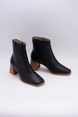 Botas cortas de cuero negro con cierre lateral y taco de madera.