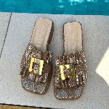 Zueco marrón de cuero vacuno con capellada fruncida y hebilla dorada.