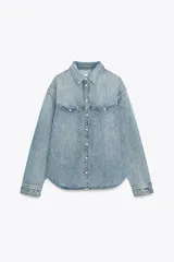 Camisa de denim celeste, de corte recto, con cuello solapa, manga larga, dos bolsillos frontales con solapa y cierre frontal con botones.