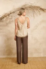 Musculosa lencera color beige con breteles de encaje desflecado.