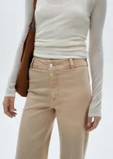 Pantalón de jean color beige, corte culotte, tiro alto y bajo desflecado.