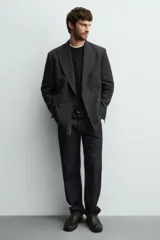 Mocasín de cuero color marrón oscuro con detalle de antifaz en el empeine, plantilla de cuero, horma cuadrada y suela a tono con ligero tacón.