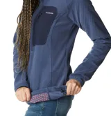 Buzo polar Columbia negro con cuello alto y cierre 1/2. Cuenta con tecnología Omni-Heat™ Helix, bolsillo con cremallera en el pecho y bolsillos para las manos con cremallera.