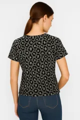 Remera de manga corta con estampado animal print en tonos marrones y beige, cuello en V y corte holgado.