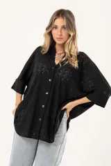 Camisa negra con calados, escote en V, abotonada y manga 3/4.