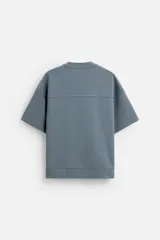 Sudadera negra de corte relaxed fit, confeccionada en tejido interlock de algodón con elasticidad. Tiene cuello redondo, manga corta y bajo acabado en rib.