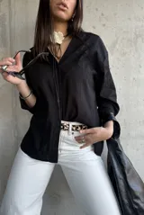 Camisa negra de manga larga con bordado floral.