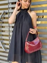 Vestido corto negro con cuello halter y corte evasé.