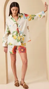 Short tipo bermuda de lino color crudo con estampado de limones, flores y girasoles. Tiene cintura elastizada con lazo ajustable y bolsillos laterales.