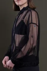 Bomber negra de tul transparente con cierre frontal y bolsillos con solapa.