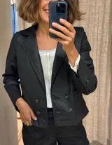 Campera corta negra estilo rockera, confeccionada en tela simil cuero con spandex.
