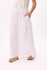 Falda larga marrón de lino y viscosa, con cintura elastizada y cordón ajustable. Tiene bolsillos laterales y corte amplio.