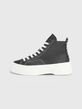 Zapatillas de caña alta Tommy Jeans, color negro, con cordones blancos y suela de plataforma blanca.
