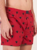 Bóxer de algodón blanco con estampado de flores pequeñas color celeste, con cintura elástica y logo de la marca en el centro.