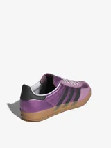 Zapatillas Adidas Gazelle Indoor color lila metalizado con detalles en negro y suela de goma color caramelo.