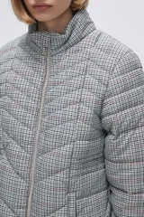 Campera puffer estampada a cuadros en blanco y negro con pequeños corazones rosados, cierre frontal con cremallera y bolsillos laterales.