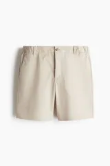 Short color beige de sarga de algodón suave, con elástico en los laterales de la cintura, cierre con botón, bolsillos al bies y bolsillos de atrás ribeteados con botón.