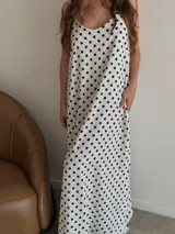 Vestido largo negro con estampado de lunares blancos, breteles finos y escote en V.