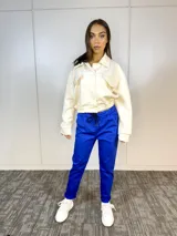 Campera corta color blanco con textura capitonada, cuello camisero, cierre frontal con botones, mangas largas con puños elastizados, cintura elastizada y bolsillos de parche con solapa en el pecho.