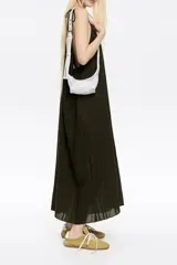 Minibolso amarillo de tejido de red con detalles en piel y charms metálicos. Presenta etiqueta logotipada BIMBA Y LOLA y cierre ajustable de cordón, con acabados metálicos plateados.