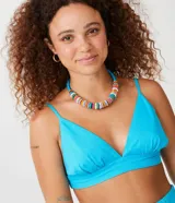 Blusa cropped de lino color celeste con tirantes finos ajustables y escote en V. Presenta elástico en la espalda.