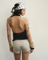 Top negro de microfibra drapeado con escote buche y espalda descubierta. Largo hasta la cadera.