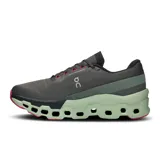 Championes de running On Cloudmonster 2, color negro con detalles en verde y rosa.
