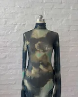 Minivestido de microtul elastizado con estampado abstracto en tonos verde, marrón y azul. Diseño ajustado al cuerpo, cuello alto y mangas largas.