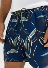 Short de baño azul con estampado de hojas en tonos verde y blanco.