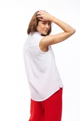 Blusa blanca sin mangas con escote en V.