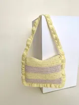 Cartera tejida a crochet con hilo 100% de algodón, con diseño a rayas y volados bordeando la cartera extendiéndose hacia la manija.