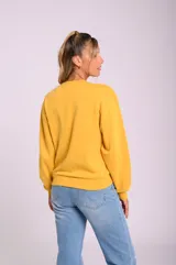 Buzo amarillo con cuello redondo y estampado frontal con la frase 'self love baby' en color rosa.