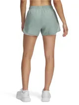 Short deportivo Under Armour Fly By 2 in 1 para mujer, color verde agua con detalles en blanco. Cuenta con cintura elástica, calza interior incorporada y bolsillo lateral con cierre.