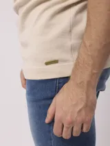 Remera de mangas cortas color beige, tejida en punto liso.