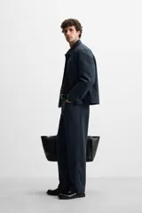 Pantalón azul marino de corte recto, confeccionado en tejido de algodón y lyocell. Cuenta con bolsillos delanteros y traseros.