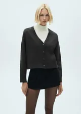 Cardigan de punto fino color gris oscuro, con cuello en pico y cierre de botones en la parte delantera.