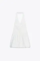 Minivestido negro con forma de chaleco, cuello halter, escote en pico, botones metálicos y bajo globo.