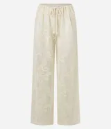 Pantalón de playa blanco de encaje floral con cintura elastizada ajustable con cordón.