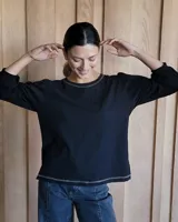 Remera negra de mangas largas con detalle de costuras en color gris en cuello y ruedo.