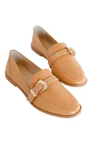 Mocasines color camel con textura símil piel de reptil y detalle de hebilla dorada.